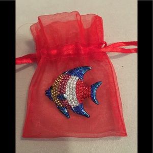 Vibrant colored fish brooch with red organza bag